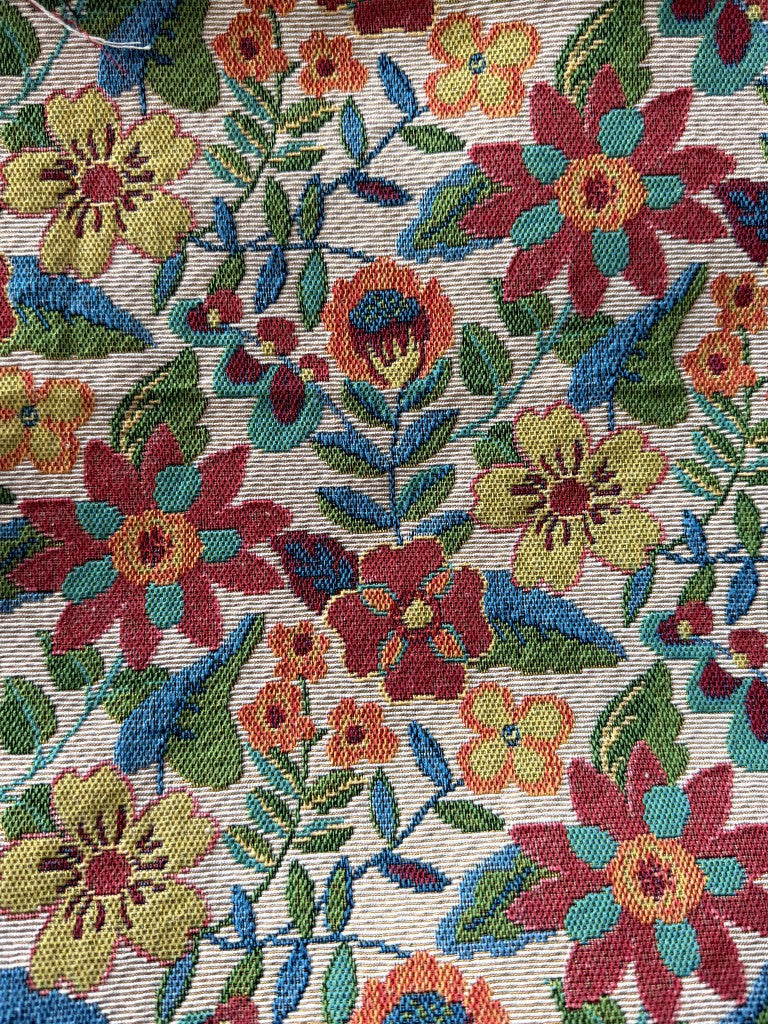 Close-up of cream-ground garden folk floral linen-like polyester jacquard weave