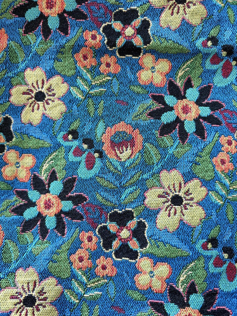 Blue-ground colorway of garden folk floral linen-like polyester jacquard fabric