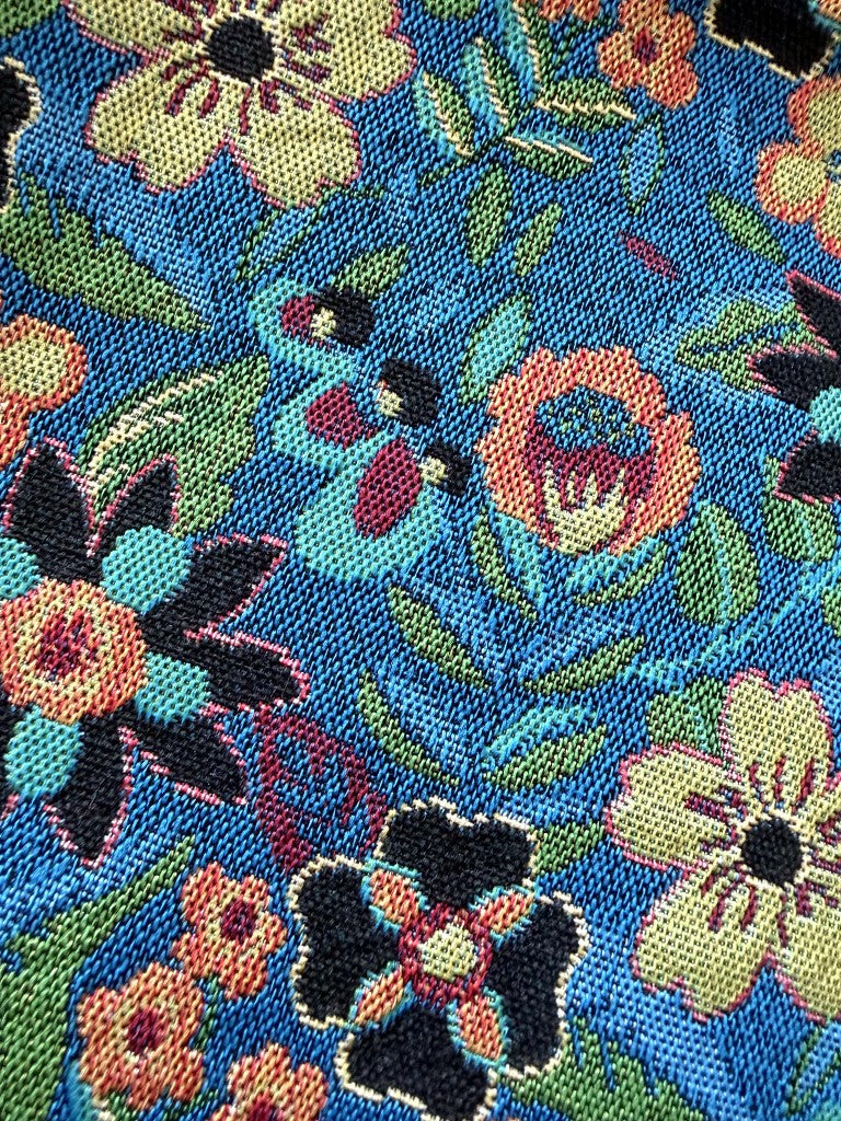 Detail of blue-ground garden folk floral polyester jacquard with linen-like texture